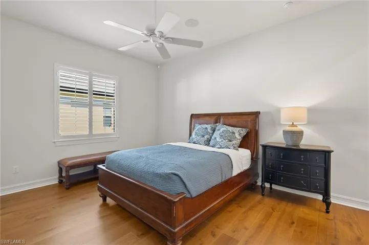Bedroom featuring ceiling fan and hardwood / wood-style floors