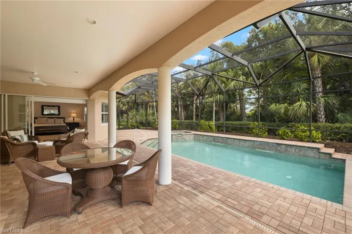 View of pool with a lanai, ceiling fan, outdoor lounge area, a patio, and an in ground hot tub
