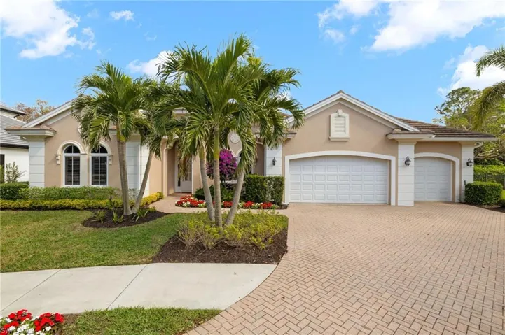 View of front of home with a garage and a front lawn
