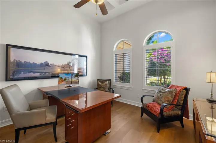 Office space featuring vaulted ceiling, plenty of natural light, ceiling fan, and light hardwood / wood-style flooring