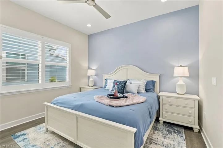 Recessed lighting, ceiling fan, wood-finish flooring, white plantation shutters, and a pastel accent wall