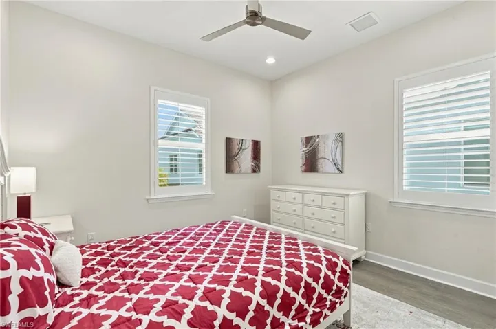 Recessed lighting, ceiling fan, wood-finish flooring, and window blinds
