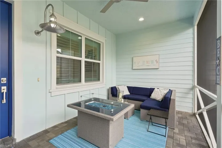 Screened patio featuring a ceiling fan, recessed lighting, plank siding, and paver flooring