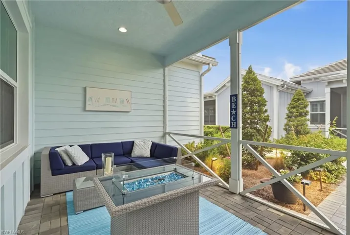 Screened outdoor patio featuring a ceiling fan, recessed lighting, and a paver stone surface