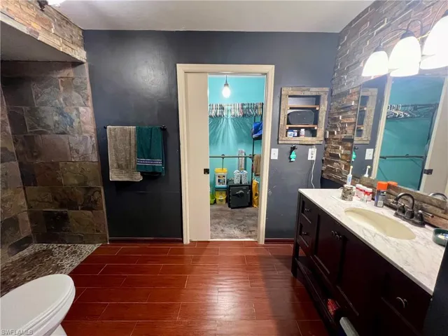 Primary Bathroom with walk in shower, vanity, and toilet