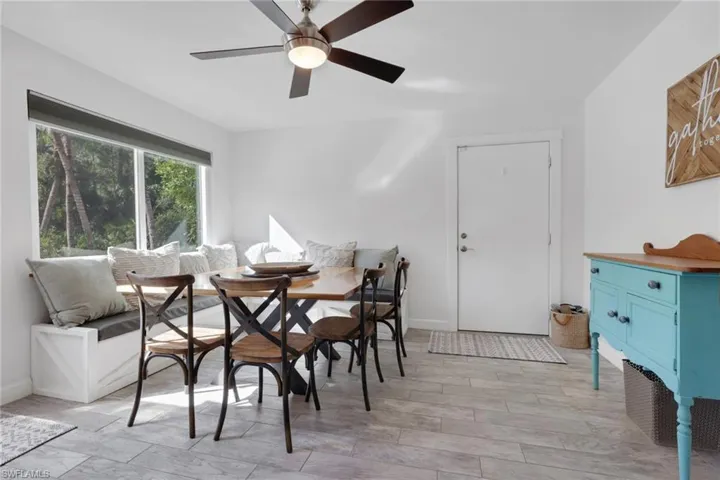 Dining Area off the kitchen with tons of natural lighting and a beautiful view of the pool area, custom built seating that can also be used for added storage
