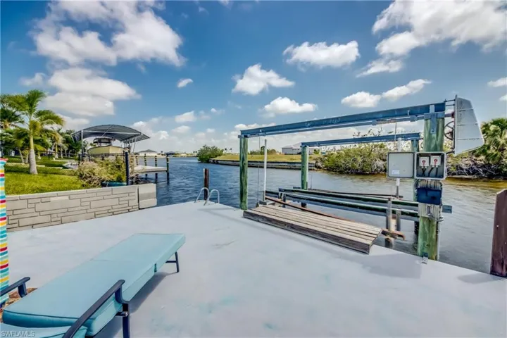 Dock area with a water view and boat lift
