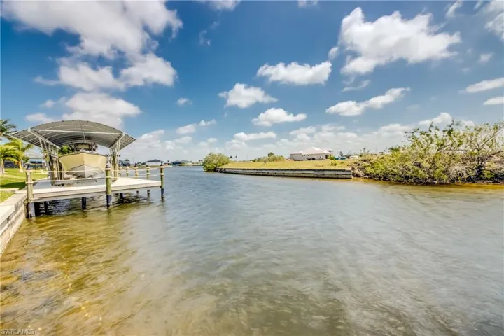 Dock area with a water view and boat lift
