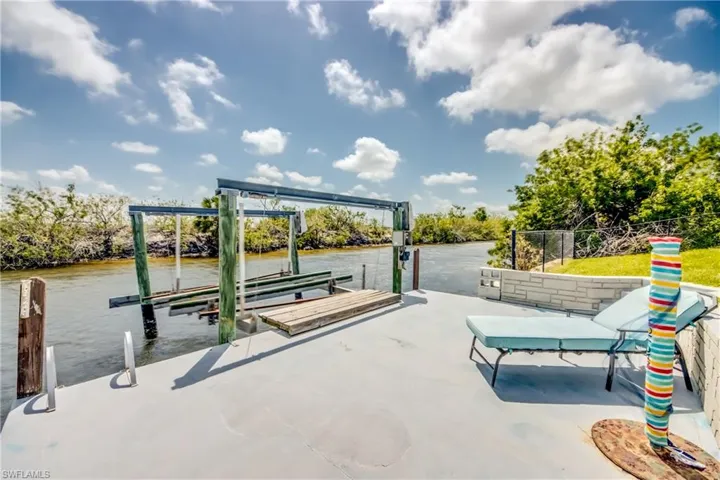 Dock area with a water view and boat lift