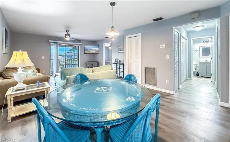 Open living area with entry to private screened in balcony.