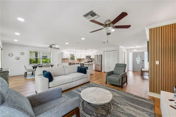 Living room featuring light hardwood / wood-style flooring and ceiling fan