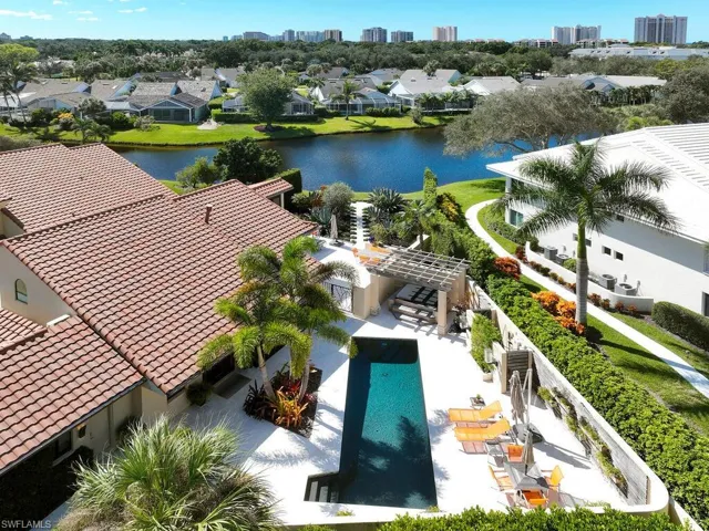 Drone / aerial view of a pool area and a large body of water