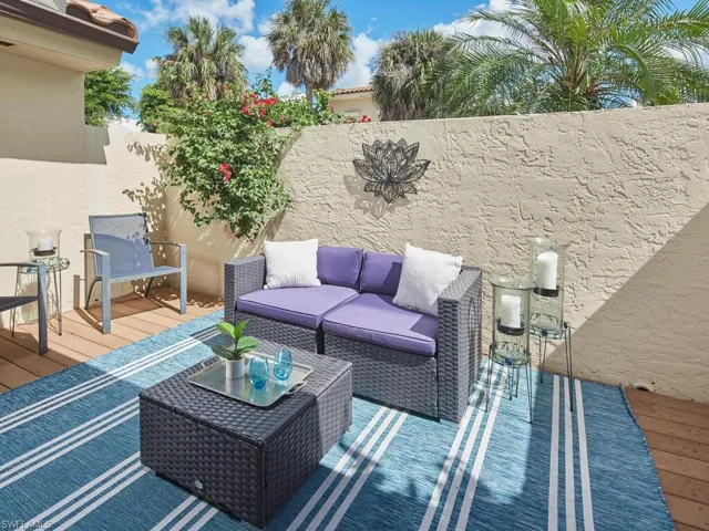 Fenced backyard featuring an outdoor living space and a deck