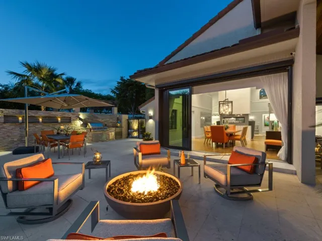 View of patio featuring outdoor dining area, exterior kitchen, and a fire pit