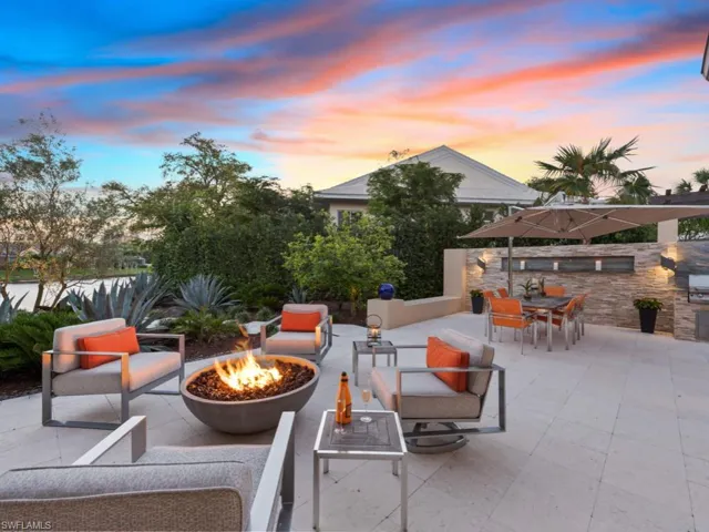 View of patio / terrace with outdoor dining space, an outdoor fire pit, and exterior kitchen