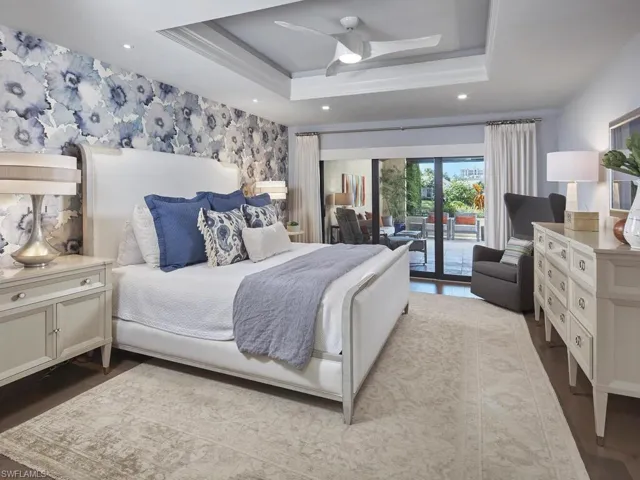 Bedroom with a raised ceiling, ceiling fan, access to exterior, wallpapered walls, and recessed lighting
