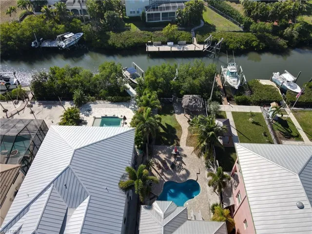 Drone / aerial view of pool and saltwater canal in rear