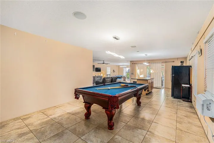 Family/Game room on first level with billiards table, a textured ceiling, a ceiling fan, and cooling unit