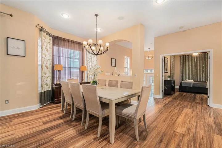 Dining room featuring wood finished floors, a chandelier, and recessed lighting
