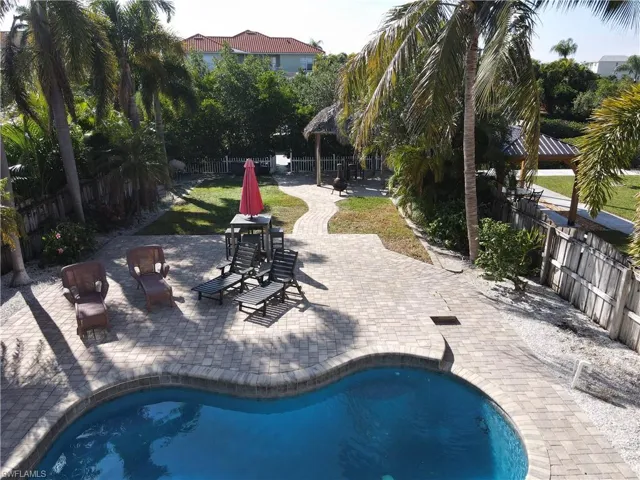 View of swimming pool with a patio and a fenced backyard