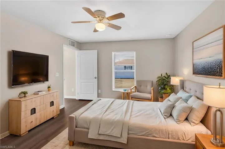 Bedroom with dark wood-style flooring and a ceiling fan
