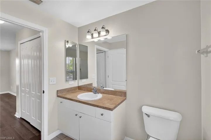 Half bathroom with vanity and toilet