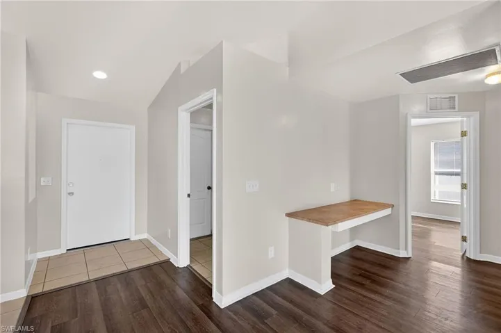 Foyer featuring dark wood-style floors and recessed lighting