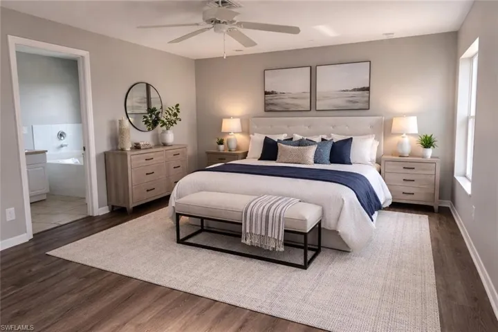 Bedroom with ceiling fan, dark wood finished floors, and ensuite bathroom