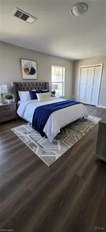 Bedroom with dark wood-style flooring
