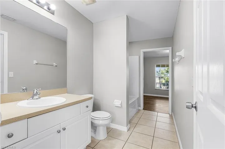 Bathroom with vanity and light tile patterned flooring