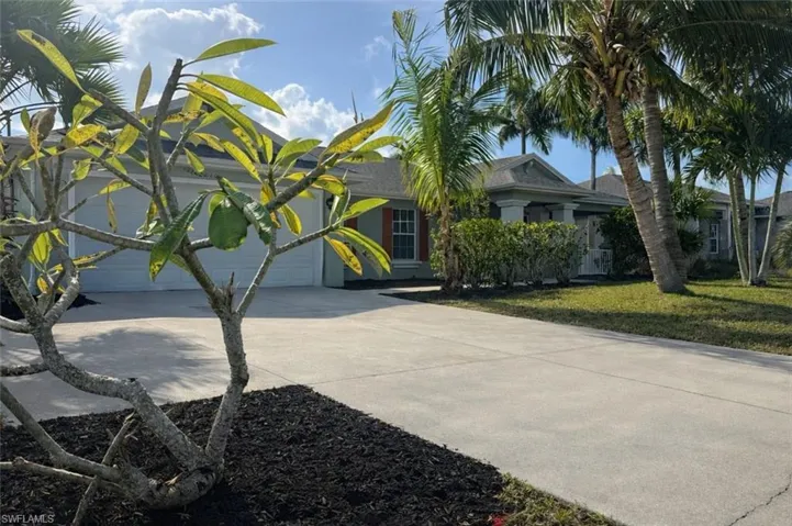 View of front of home with driveway and a front yard