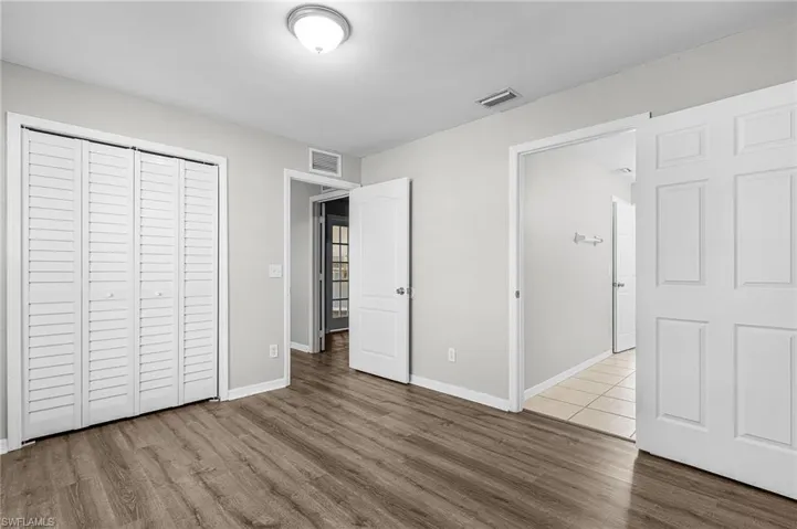 Unfurnished bedroom with light wood-style floors and a closet