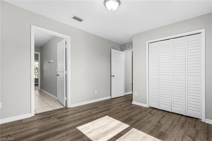 Unfurnished bedroom featuring a closet and wood finished floors