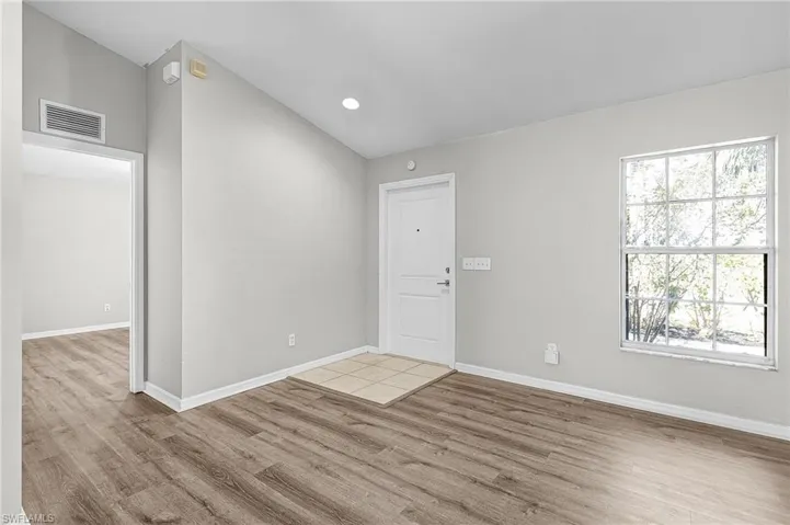 Entryway with light wood-style flooring and recessed lighting