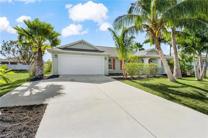 Single story home with stucco siding, driveway, and an attached garage
