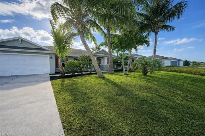 Single story home with concrete driveway, a front lawn, a garage, and stucco siding