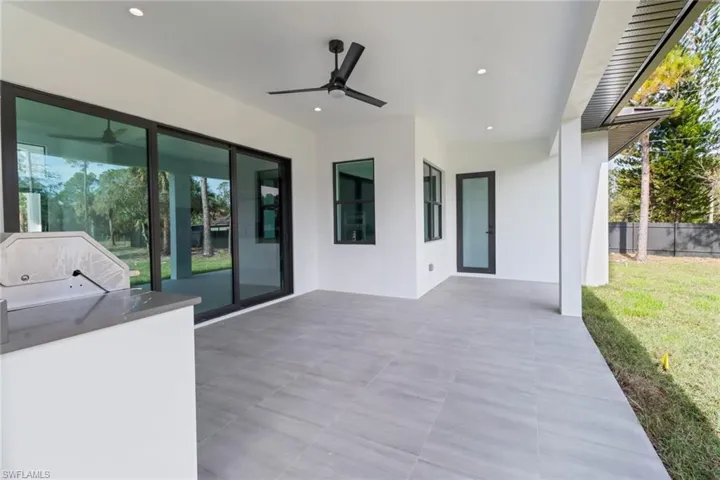 View of patio with ceiling fan and exterior kitchen