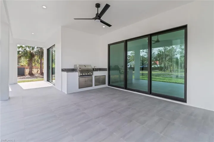 View of patio / terrace featuring area for grilling, ceiling fan, and grilling area