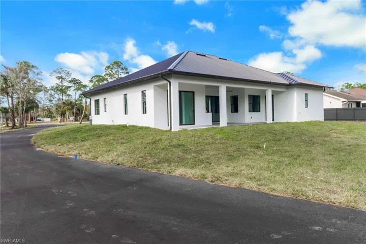 View of property exterior featuring a lawn