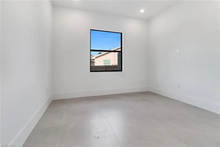 Empty room featuring light tile patterned floors
