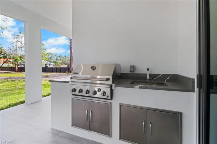 View of patio / terrace with a grill, sink, and area for grilling