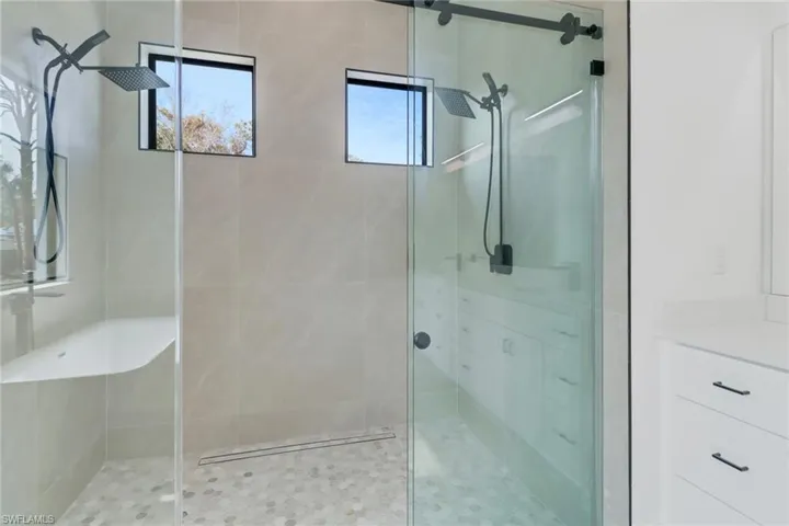 Bathroom featuring vanity and a shower with shower door