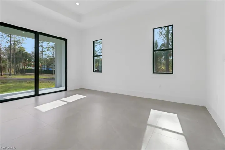 Tiled empty room featuring plenty of natural light