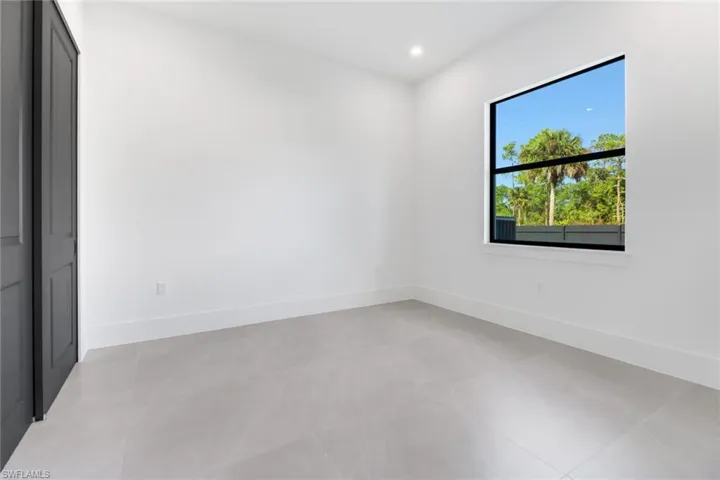 Spare room with light tile patterned flooring