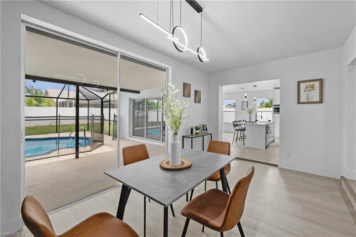 Dining area with plenty of natural light, a chandelier, and light wood-type flooring
