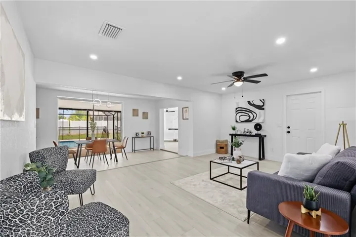 Living room featuring ceiling fan and light hardwood / wood-style floors