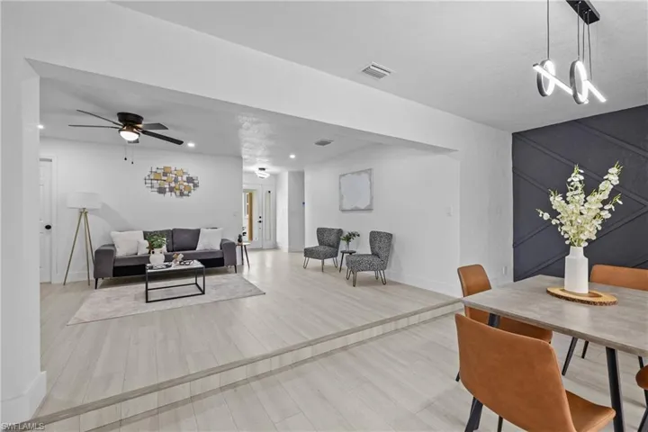 Living room with light wood-type flooring and ceiling fan