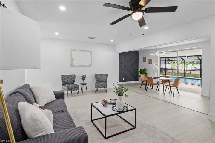 Living room featuring ceiling fan and light wood-type flooring