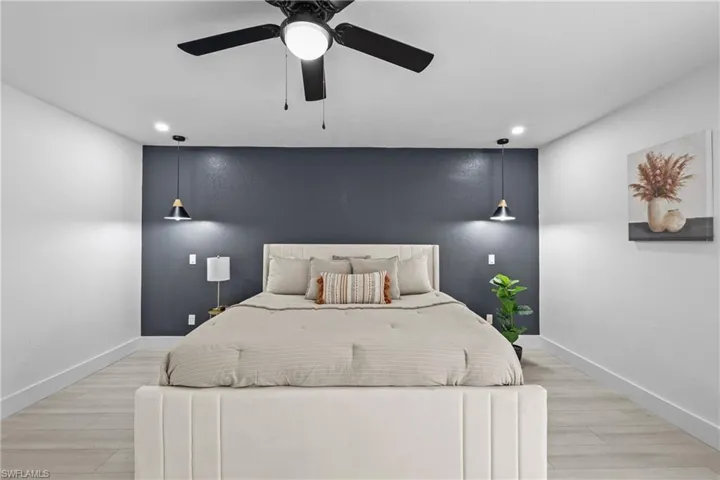 Bedroom featuring ceiling fan and light hardwood / wood-style floors