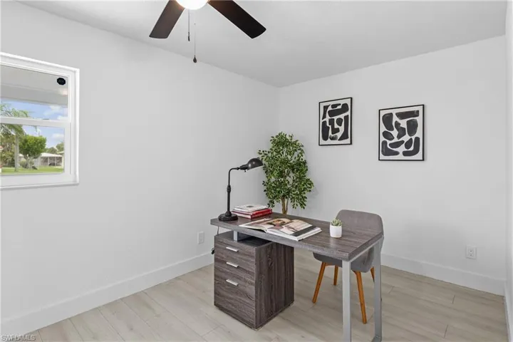 Office area featuring light wood-type flooring and ceiling fan